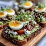 Spring Brunch Avocado Toast Board with Toppings features creamy avocado spread on toasted sourdough, topped with colorful radishes, cherry tomatoes, and feta cheese.