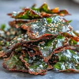 Crispy baked seaweed snack chips sprinkled with sesame seeds and sea salt.