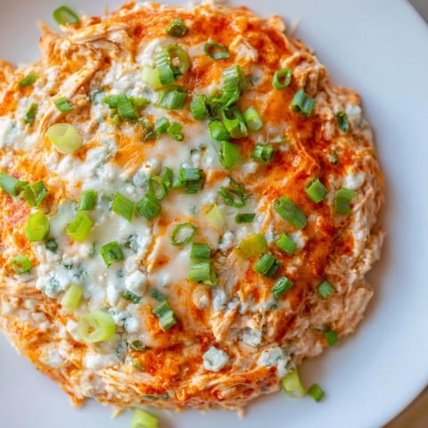 Warm, creamy Buffalo Chicken Dip, loaded with shredded chicken and a tangy hot sauce flavor.