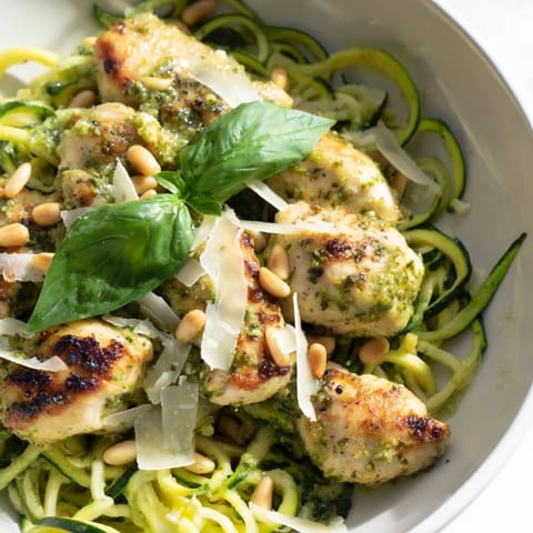 Tender pesto zucchini chicken bowl features spiralized zucchini, juicy chicken, and a bright lemony finish, perfect for a light low-carb dinner.