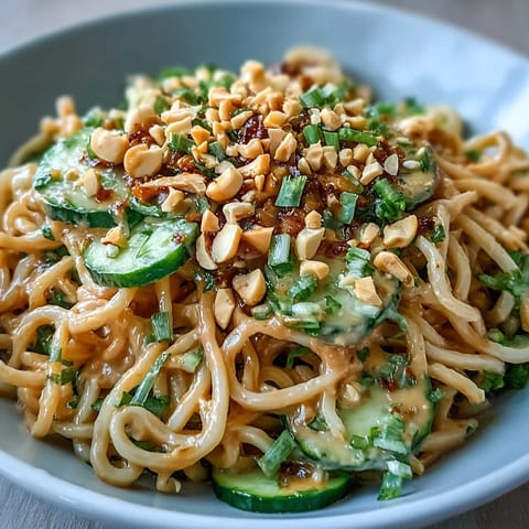 Creamy cold peanut sesame noodles with crisp cucumber, a refreshing Asian meal.