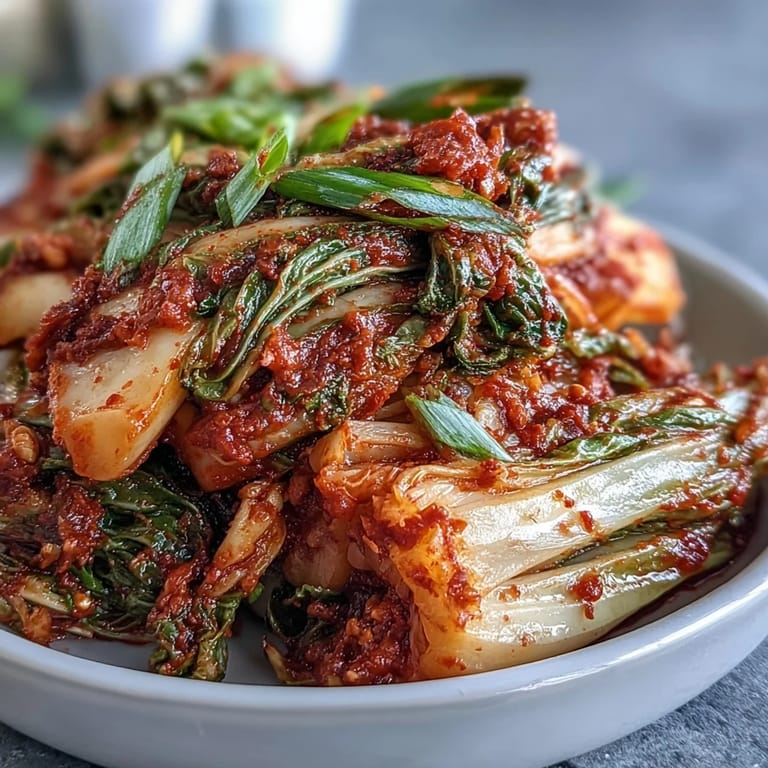 Bright red kimchi overflowing from a jar, ready for delicious fermentation.