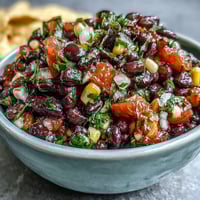 Three-Ingredient Cowboy Caviar Dip: A colorful mix of black beans, sweet corn, and zesty pico de gallo in a serving bowl.